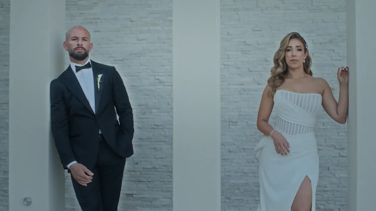 Couple portraits against a stone wall in bounced light